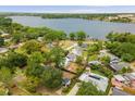 Beautiful aerial view of neighborhood homes and lake with city skyline in the distance at 490 Shoreview Ave, Winter Park, FL 32789