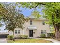 Charming two-story home with black front door, manicured landscaping and mature trees at 490 Shoreview Ave, Winter Park, FL 32789