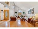Bright living room with vaulted ceilings, wood floors, and ample seating at 513 Sabal Trail Cir, Longwood, FL 32779