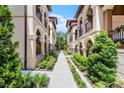 Townhome exterior featuring a sidewalk and landscaped beds leading to covered entrances at 524 Lobelia Dr, Lake Mary, FL 32746