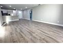 Open-concept living room with new wood flooring and bright, neutral paint at 534 Central Ave, Frostproof, FL 33843