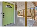 View of the house number, light green front door and covered parking area at 900 Citrus St, Orlando, FL 32805