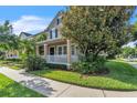Beautiful home exterior with a manicured lawn, mature trees, and a welcoming front porch at 9189 Camden Gardens St, Orlando, FL 32827