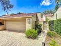 Townhome with a two-car garage and charming walkway to gated front entrance at 103 Red Cedar Dr, Longwood, FL 32779
