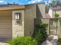 Close up of a townhome entrance with lovely landscaping and a paved walkway at 103 Red Cedar Dr, Longwood, FL 32779