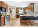 Updated kitchen featuring wood cabinets, granite countertops, tile backsplash and an island with bar seating at 1032 Perkins Rd, Orlando, FL 32809