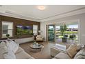 Bright living room featuring hardwood floors, recessed lights, a modern decor, and a patio view at 10529 Royal Cypress Way, Orlando, FL 32836
