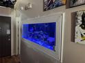 Unique built-in aquarium with colorful fish, adding a distinctive design element to the home's interior at 1112 Winding Water Way, Clermont, FL 34714