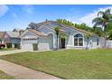Charming single-Gathering home boasting mature landscaping and well-maintained lawn at 11836 Hartfordshire Way, Orlando, FL 32824
