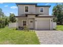 Charming two-story home with a well-maintained front yard and a brick-paved driveway leading to the garage at 146 E 15Th St, Apopka, FL 32703