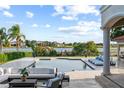 Luxury outdoor area features a beautiful pool overlooking a tranquil lake with comfortable seating and lounge chairs at 14724 Avenue Of The Rushes, Winter Garden, FL 34787
