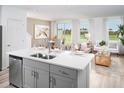 Open-concept kitchen featuring stainless steel appliances, breakfast bar, and seamless access to the living area at 16382 Bird Of Paradise Ave, Clermont, FL 34714