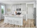 Bright, eat-in kitchen with white countertops, modern appliances, and light wood flooring at 16382 Bird Of Paradise Ave, Clermont, FL 34714
