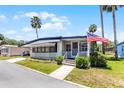 Cozy home with an American flag, featuring a well-kept lawn and inviting entrance at 200 Palm Meadows Dr, Eustis, FL 32726