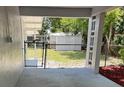 Covered back porch featuring a view of the fenced backyard and storage shed at 205 Brighton Way, Casselberry, FL 32707