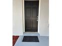 Inviting front door with a 'Welcome' mat, framed by a freshly painted exterior at 205 Brighton Way, Casselberry, FL 32707