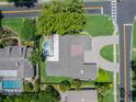 Birds eye view of home featuring a pool, brick driveway and lush landscaping at 2106 Tuscarora Trl, Maitland, FL 32751