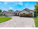 Charming home exterior showcasing brick driveway and well-maintained landscaping at 2106 Tuscarora Trl, Maitland, FL 32751