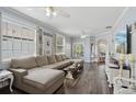 Spacious living room featuring dark wood floors, neutral decor, and lots of natural light at 2215 Guiana Plum Dr, Orlando, FL 32828