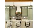 Modern open kitchen with a white island, pendant lighting and custom cabinetry at 2349 Plantation Oak Dr, Orlando, FL 32824