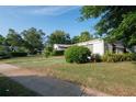 Well-manicured front yard with green grass, landscaping, and a painted driveway for curb appeal at 2361 Kimberly Dr, Deltona, FL 32738