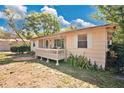 Cozy single story home with front porch and lush, green lawn creates inviting curb appeal at 2409 Garbelia Ave, Orlando, FL 32817