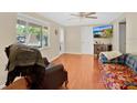 Comfortable living room with hardwood floors and natural light offers a cozy atmosphere for relaxing or entertaining at 2409 Garbelia Ave, Orlando, FL 32817