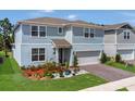 Charming two-story home with a well-maintained lawn and a two-car garage at 2449 Southlawn Ln, Clermont, FL 34714