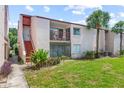 Inviting condo exterior featuring a private balcony, lush landscaping, and vibrant green lawn at 2486 Citrus Club Ln # 408, Orlando, FL 32839