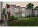 Inviting condo exterior featuring a private balcony, lush landscaping, and vibrant green lawn at 2486 Citrus Club Ln # 408, Orlando, FL 32839