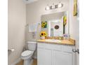 Cozy powder room featuring a classic vanity and charming sunflower decor at 281 Primrose Dr, Davenport, FL 33837