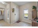 Bright foyer with tile flooring, natural light, and a charming mail station at 281 Primrose Dr, Davenport, FL 33837