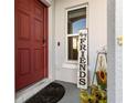 Close-up of a welcoming front door with a decorative sign and neat landscaping at 281 Primrose Dr, Davenport, FL 33837
