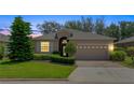 Well-maintained one-story home featuring a manicured lawn, traditional architecture, and a two-car garage at 3677 Serena Ln, Clermont, FL 34711