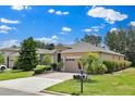 Inviting single-story home with a two-car garage, a well-maintained lawn, and mature landscaping at 3677 Serena Ln, Clermont, FL 34711