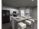 Contemporary kitchen with granite island, barstool seating, stainless steel appliances, and ample cabinet space at 4533 Cross Prairie Pkwy, St Cloud, FL 34772