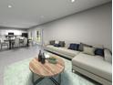 Spacious open-concept living room with contemporary decor, light-colored sectional sofa, and seamless flow to the dining area at 4537 Cross Prairie Pkwy, St Cloud, FL 34772