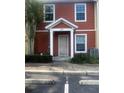 Close-up of the front entrance with a decorative storm door, manicured bushes, and modern siding at 4650 Staghorn Dr # 500, Orlando, FL 32808