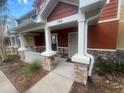 Inviting front porch with stone-detailed columns and a secure storm door, perfect for relaxing at 4650 Staghorn Dr # 500, Orlando, FL 32808
