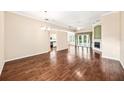 Spacious living area with hardwood floors and a view of the pool through glass doors at 487 Foxhill Dr, Debary, FL 32713