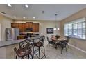 Kitchen featuring stainless steel appliances, bar stool seating, and a dining area at 5154 Majestic Woods Pl, Sanford, FL 32771