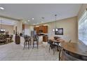 Kitchen with stainless steel appliances, breakfast bar, and adjacent dining area at 5154 Majestic Woods Pl, Sanford, FL 32771