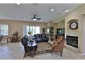 Spacious living room features comfortable seating, a cozy fireplace, and a ceiling fan at 5154 Majestic Woods Pl, Sanford, FL 32771