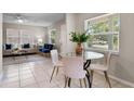 Cozy dining area with a glass-top table and comfortable seating, adjacent to the living room at 614 Plum Ln, Altamonte Springs, FL 32701