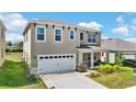 Beautiful shot of a two-story residential home featuring an attached two-car garage at 616 Griffon Ave, Lake Alfred, FL 33850