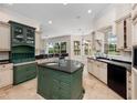 Elegant kitchen with a central island, granite countertops, and custom cabinetry at 6161 Blakeford Dr, Windermere, FL 34786