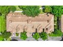 Aerial view of villas showing terracotta-tiled roofs and neatly landscaped grounds at 6205 Miramonte Dr # 103, Orlando, FL 32835