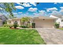 Inviting one-story home featuring a two-car garage and beautifully maintained landscaping at 7900 Saint Giles Pl, Orlando, FL 32835