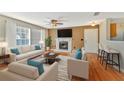 Cozy living room with a fireplace, modern furniture, and bright natural light from large windows at 935 Northern Dancer Way # 107, Casselberry, FL 32707