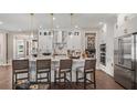 This kitchen boasts an island with seating, modern stainless appliances, and a walk-in pantry at 944 Club Cresswind Dr, Lady Lake, FL 32159